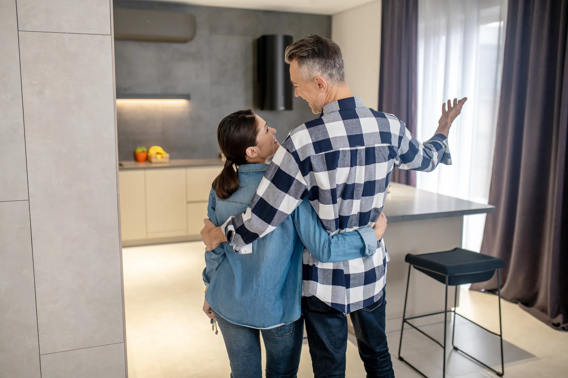 A couple with the keys to their renovated home