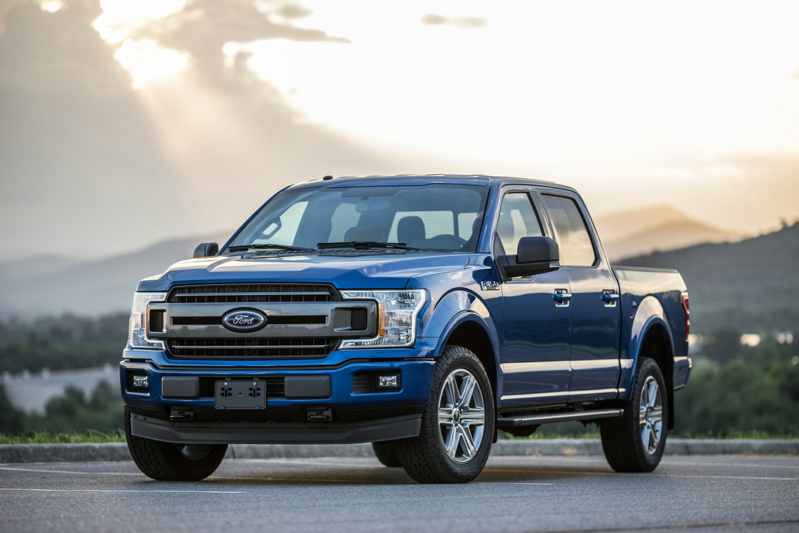 Ford F-150 truck at sunset with mountain backdrop